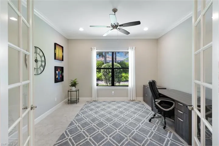 Office area with crown molding, ceiling fan, and french doors