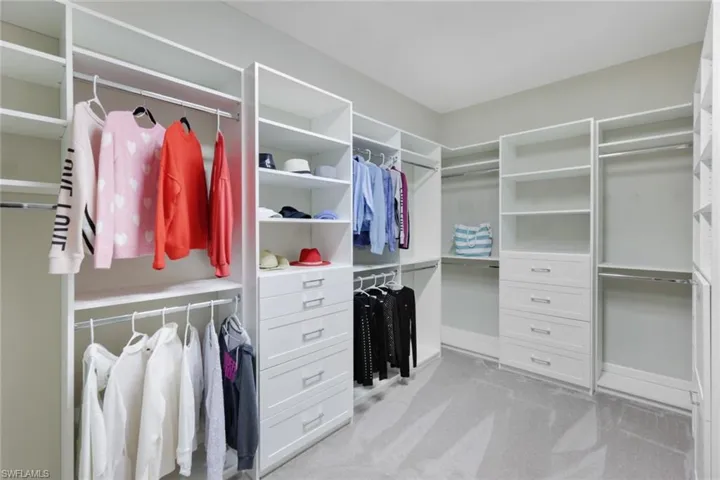 Walk in closet with full closet organizers-drawers, shelves