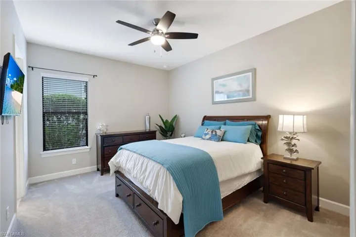 Carpeted bedroom with ceiling fan
