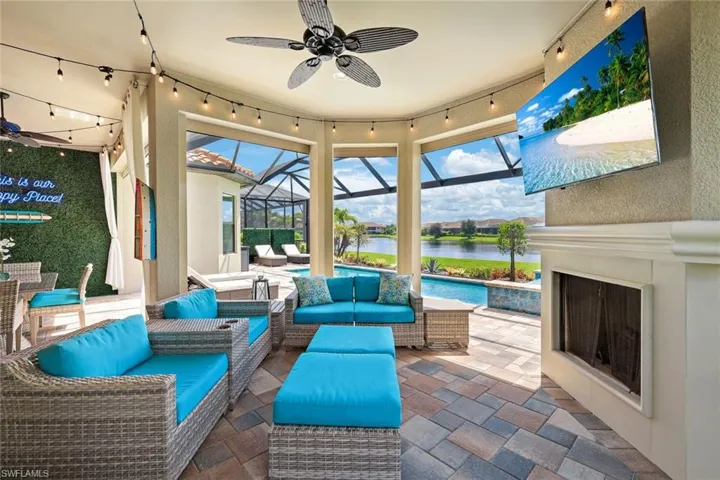 View of lanai with gas fireplace and TV overhead