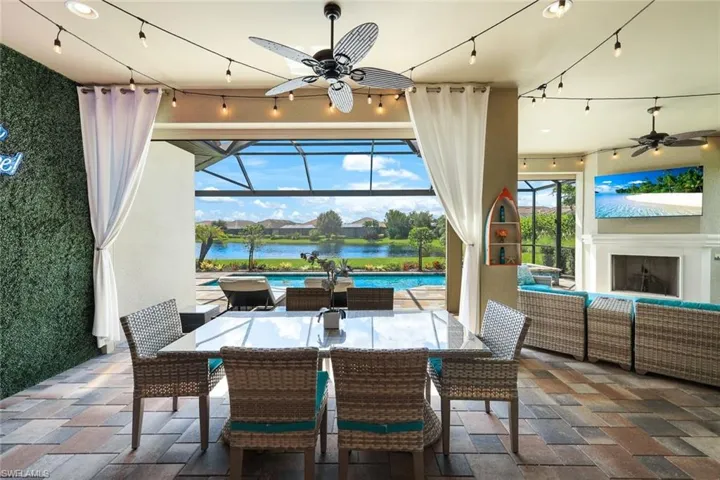 View of patio featuring a lanai, an outdoor hangout area, and ceiling fan