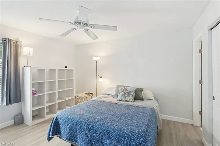 Bedroom with light wood-type flooring and a ceiling fan