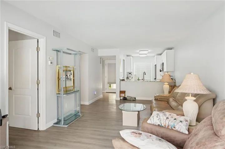 Living area with light wood-style floors and baseboards
