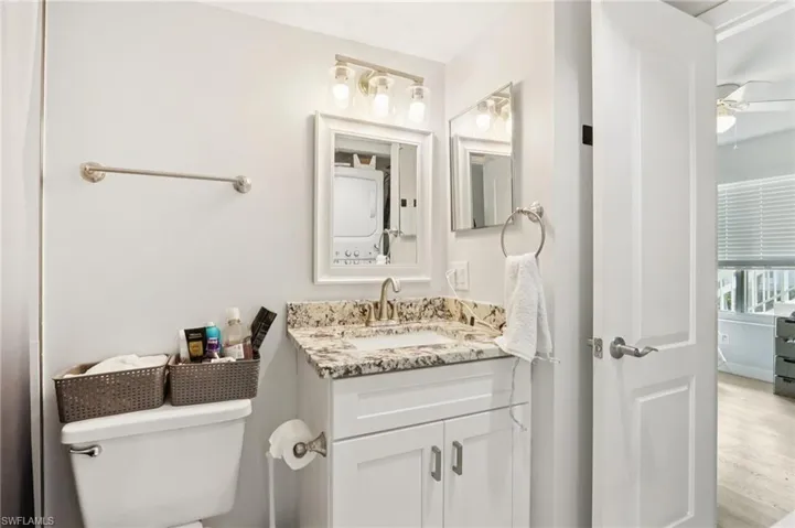 Bathroom featuring vanity, ceiling fan, and wood finished floors