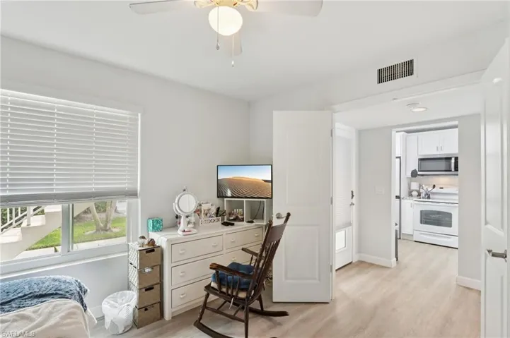 Home office with light wood finished floors and ceiling fan