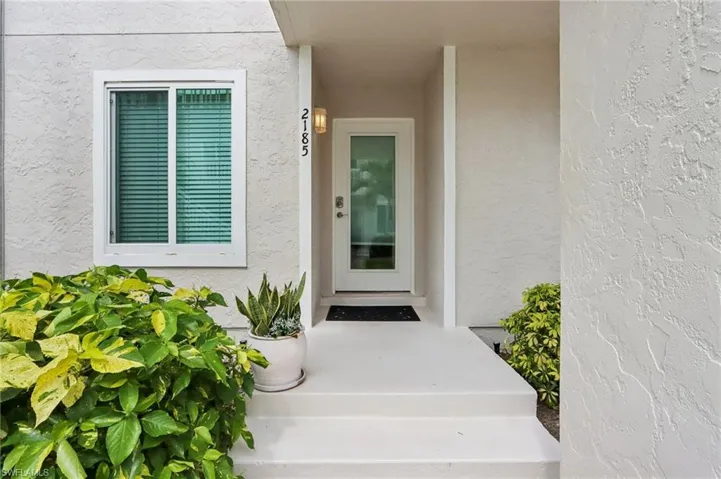 Entrance to property with stucco siding