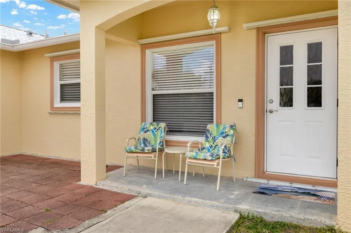 Entrance to property featuring stucco siding and a patio