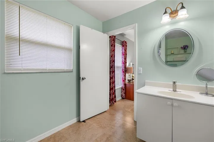 Bathroom with tile patterned flooring, vanity, and baseboards