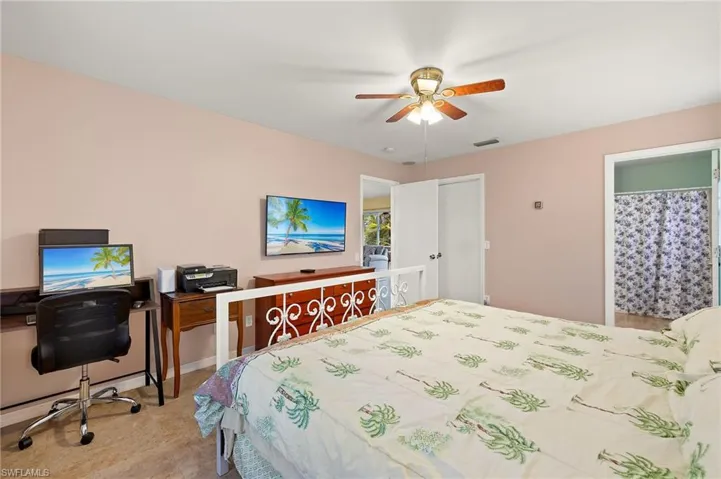 Bedroom with visible vents and ceiling fan