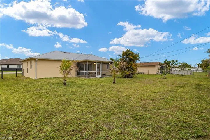 View of yard with fence and a sunroom