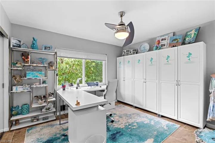 Office space with ceiling fan and light tile patterned flooring
