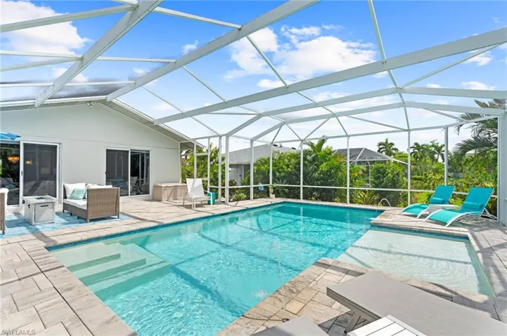 View of pool with a patio and a lanai