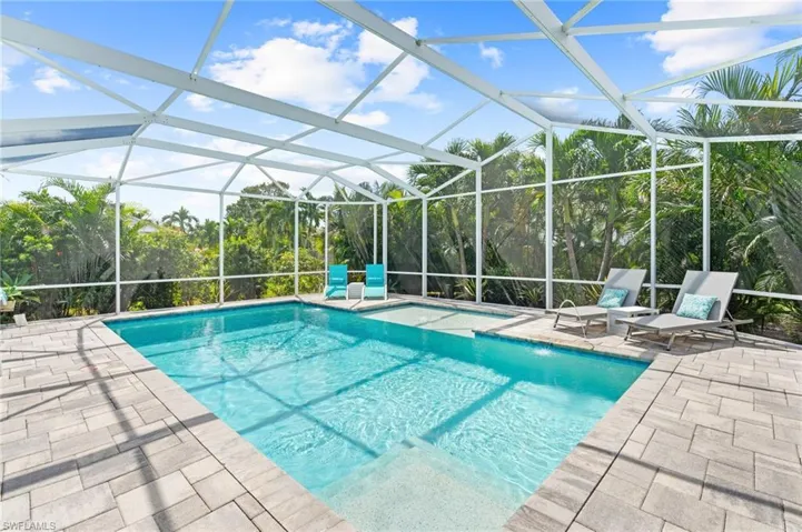 View of swimming pool with a patio and a lanai