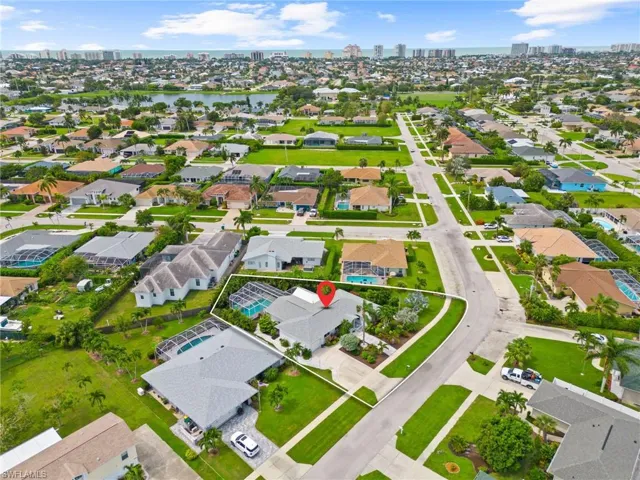 Birds eye view of property with a water view