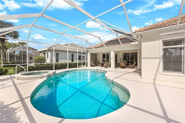 View of pool with a patio area, a lanai, and an in ground hot tub