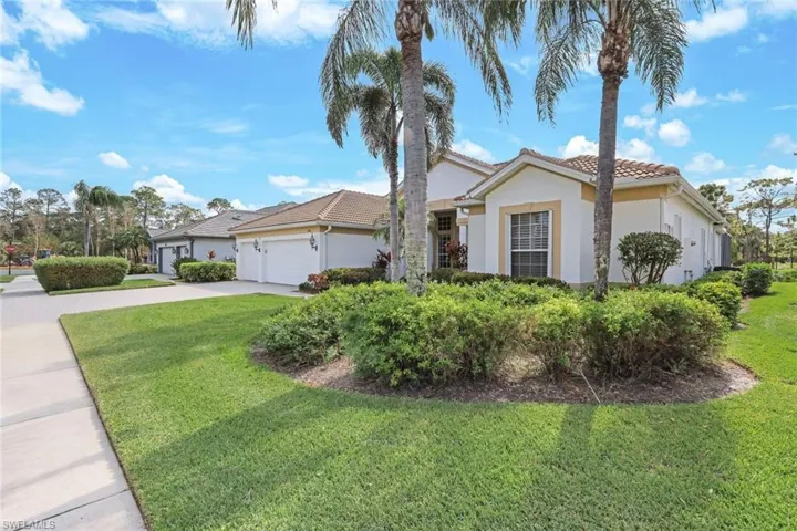 Ranch-style home with a front yard and a garage