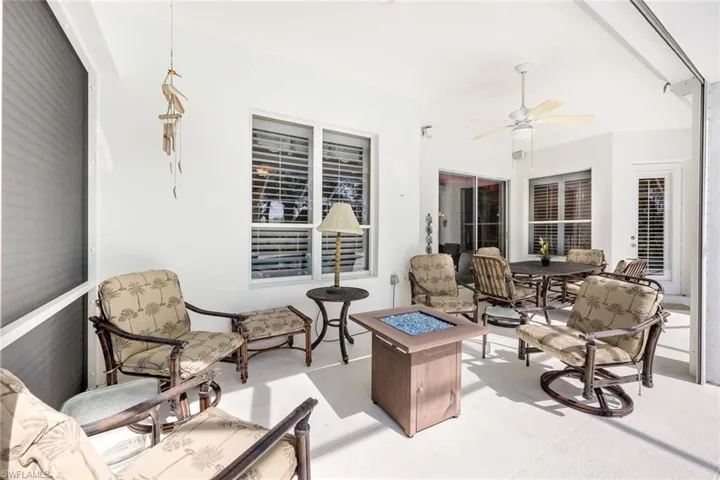 View of patio featuring ceiling fan and an outdoor living space with a fire pit