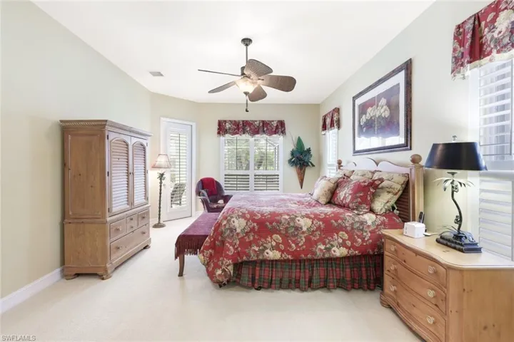 Carpeted bedroom featuring ceiling fan and access to outside