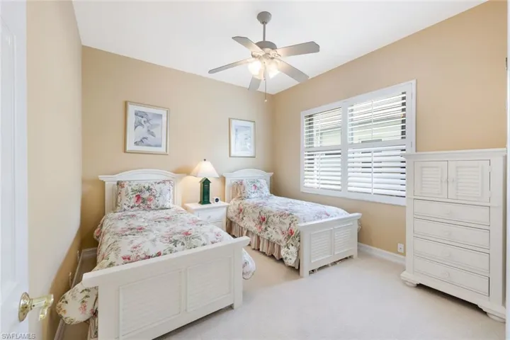 Bedroom featuring light carpet and ceiling fan