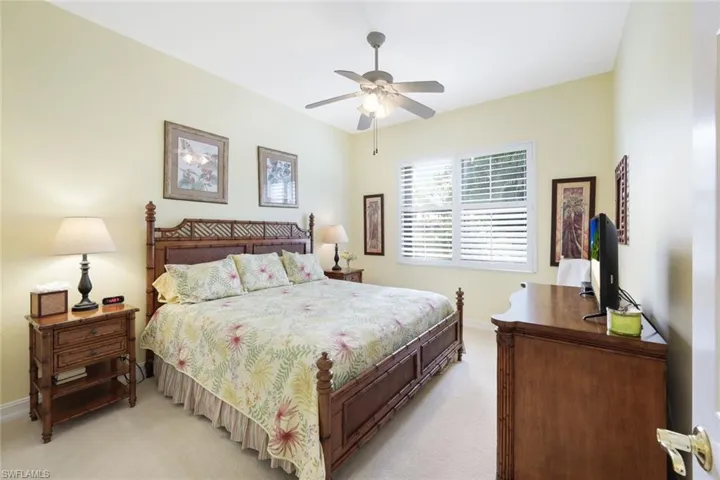 Carpeted bedroom featuring ceiling fan