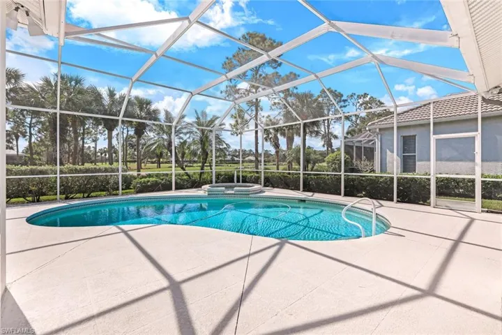 View of pool featuring an in ground hot tub, a patio area, and a lanai