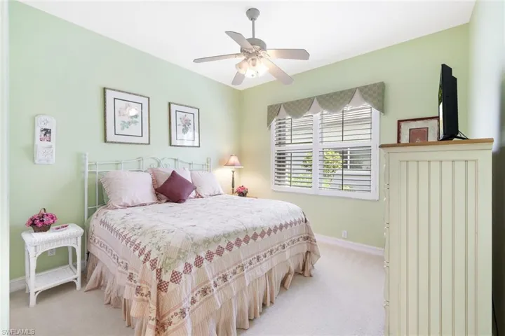 Carpeted bedroom with ceiling fan