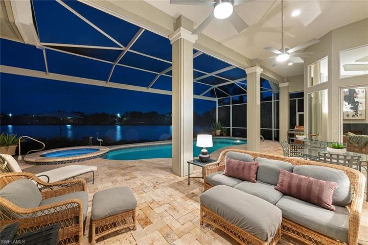 Covered lanai offering shade by day and entertaining at night.