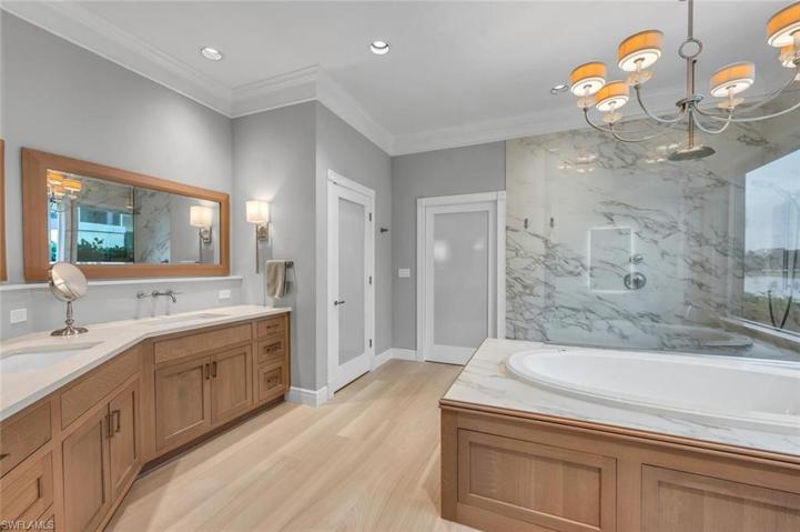 Primary bedroom spa-like bath with custom closet by Accent cabinets.