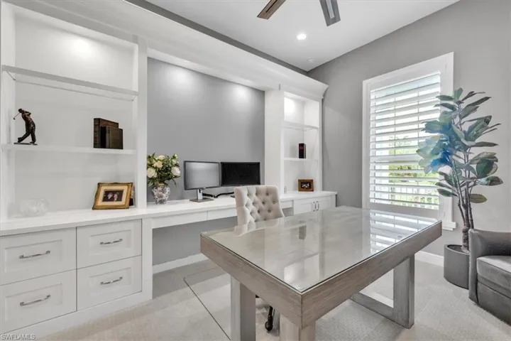 Office area with light carpet, built in desk, a ceiling fan, built in shelves, and recessed lighting