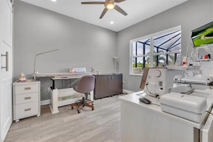 Office area featuring light wood-type flooring, recessed lighting, and a ceiling fan