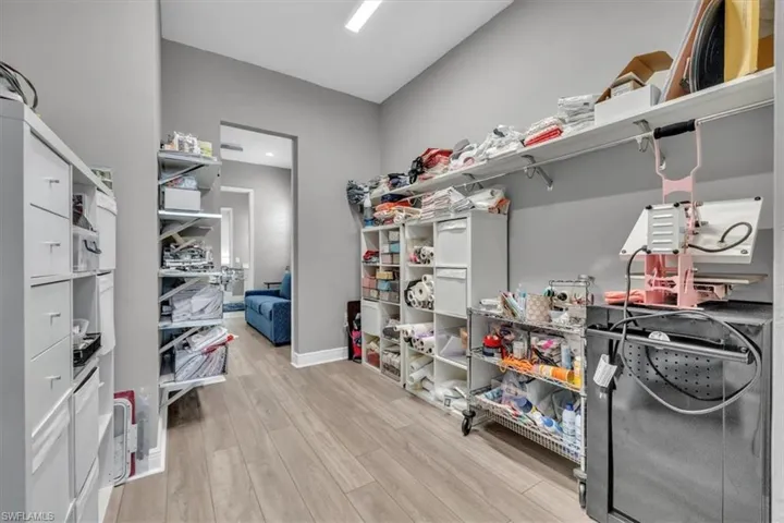 Walk in closet with light wood-type flooring