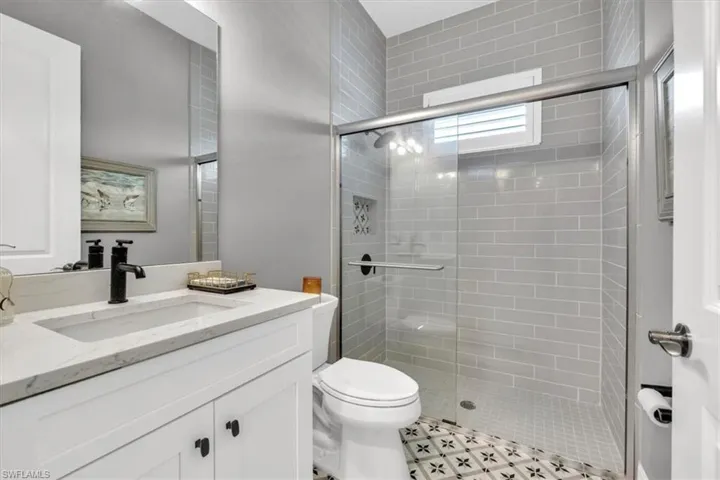 Bathroom with vanity and a stall shower