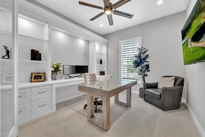 Office space with built in features, light colored carpet, a ceiling fan, and recessed lighting