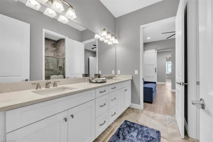 Bathroom with double vanity and a stall shower