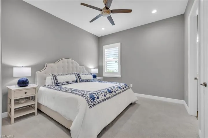 Bedroom featuring light carpet, ceiling fan, and recessed lighting