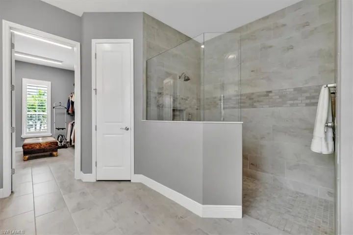 Primary Full bath with a walk in shower and tile patterned floors