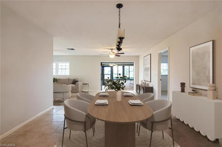 Virtually Staged, view from front by kitchen to Florida sun room.