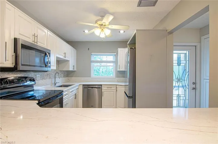 Updated kitchen features granite counter tops and custom tile backsplash!