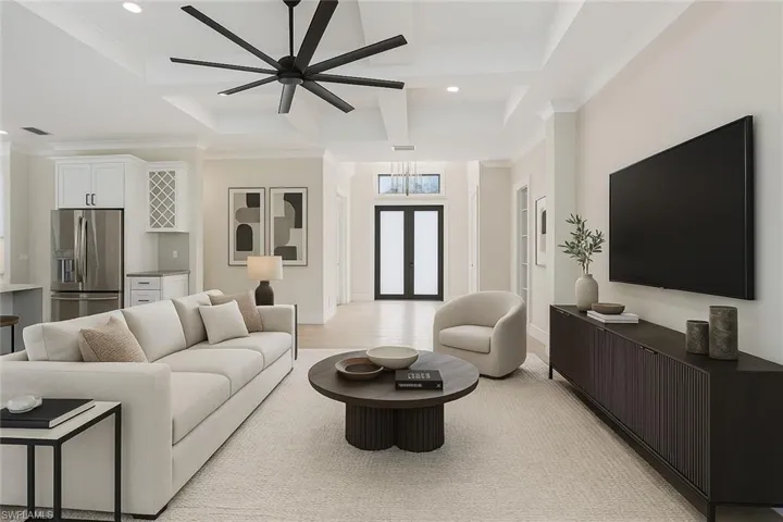 Living room featuring ceiling fan, visible vents, recessed lighting, and ornamental molding