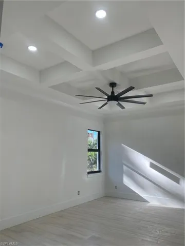 Empty room with ceiling fan, recessed lighting, beam ceiling, and baseboards