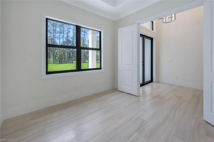 Unfurnished room featuring light wood-style floors and baseboards