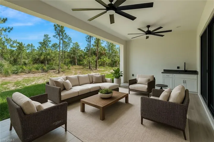 View of patio with outdoor lounge area, a ceiling fan, and a sink
