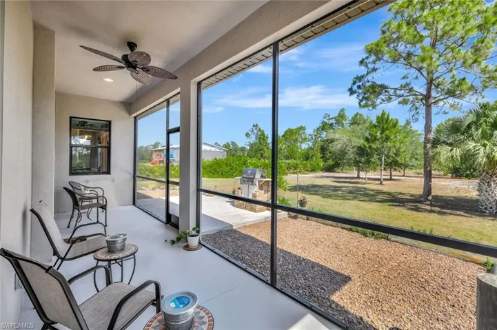 Unfurnished sunroom with ceiling fan