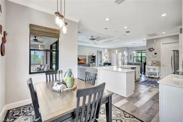 Dining space featuring ceiling fan, ornamental molding, recessed lighting, light wood-style flooring, and baseboards