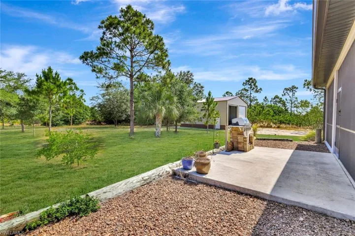 View of green lawn featuring a patio