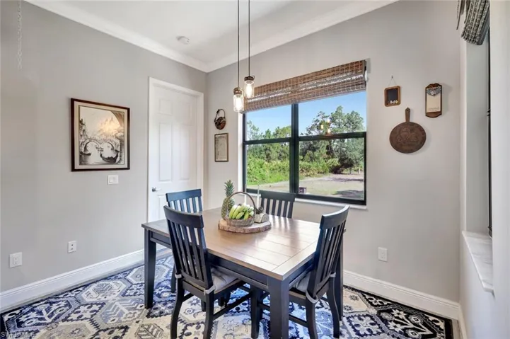 Dining area with baseboards and ornamental molding