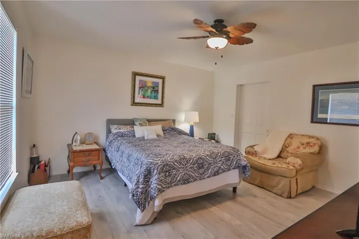 Bedroom featuring ceiling fan and wood-type flooring