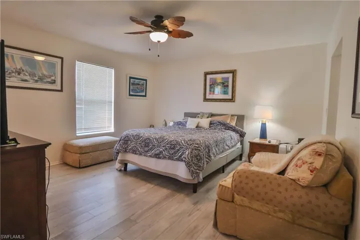 Bedroom with ceiling fan and light hardwood / wood-style flooring