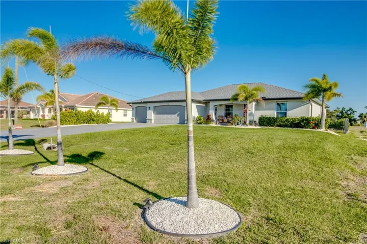 Ranch-style home with an attached garage, driveway, and a front lawn