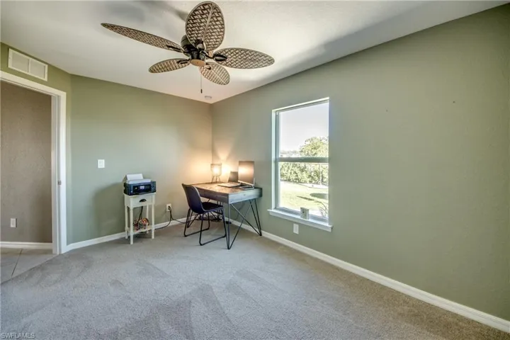Office space with carpet flooring and ceiling fan
